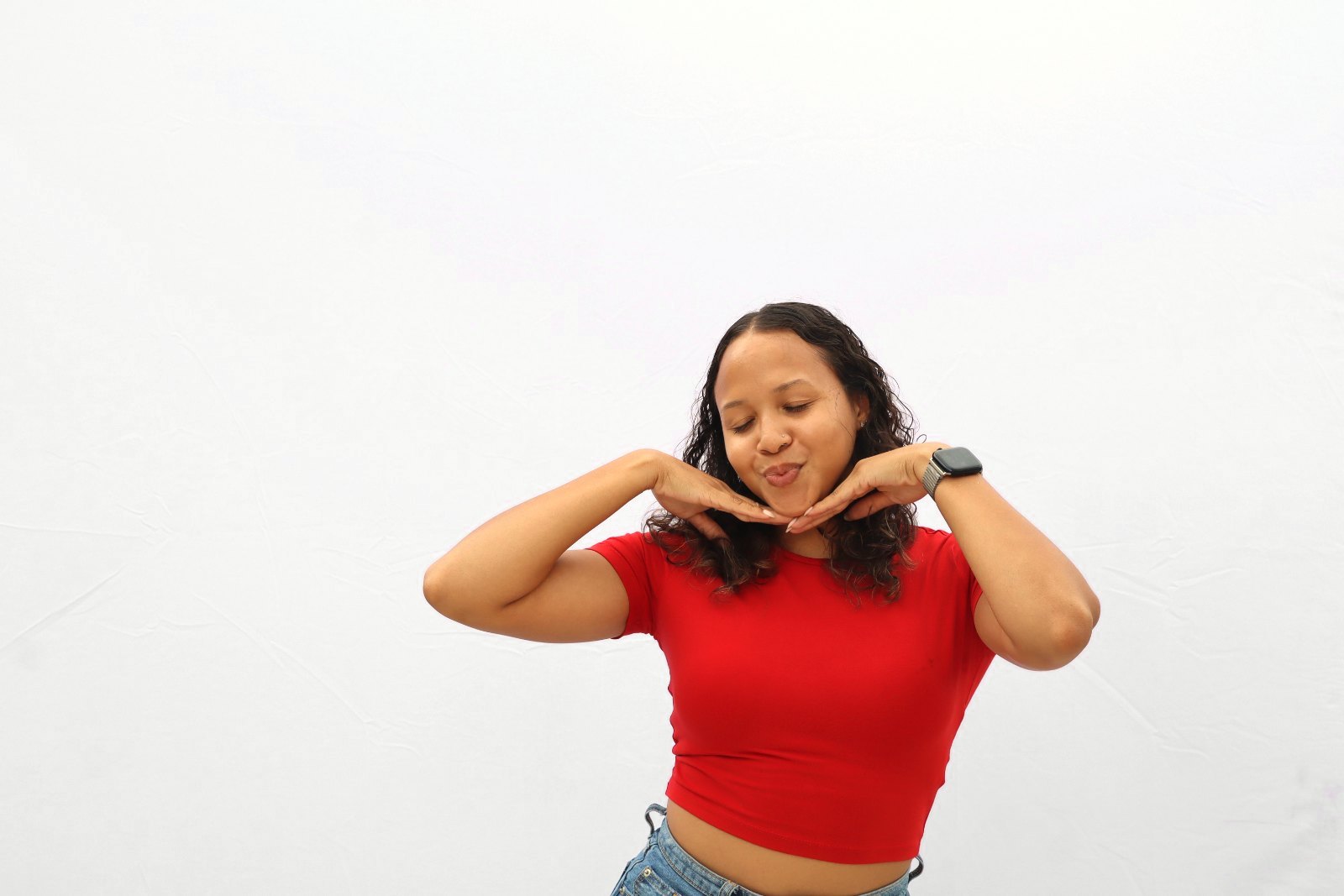A guest posing with her hands under her chin