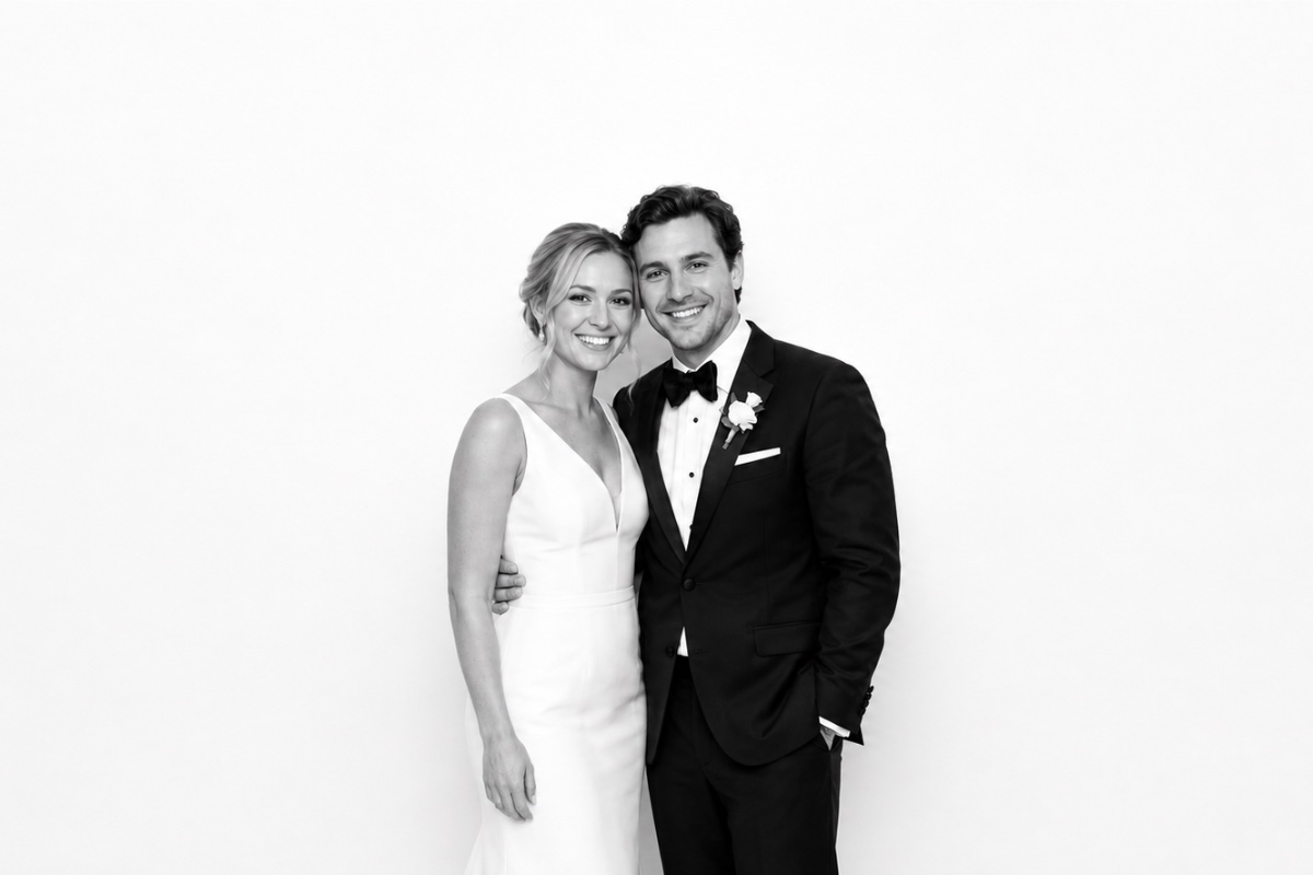 Newlyweds standing side by side, black and white