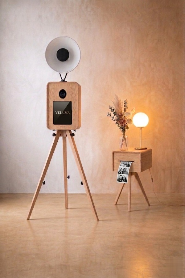 The Luma booth set up with instant prints on a side table